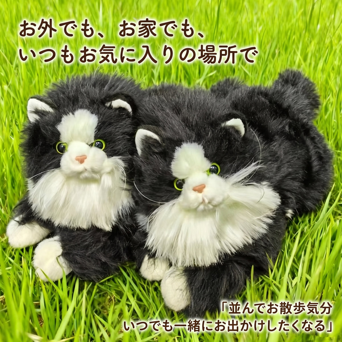 緑の芝生の上に並んで寝そべる2匹のリアルなハチワレ猫ぬいぐるみ。お外でもお家でも一緒にお出かけしたくなる愛らしい姿